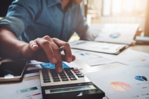 A man payroll processing with a calculator