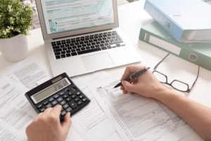 A person works on their small business tax deductions